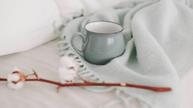 Coffee cup and cotton twig. Breakfast in bed. Cozy home. flat lay, still life.