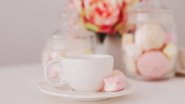 White cup with marshmallows. Romantic breakfast. Concept of holiday, birthday, Easter, International Womens Day. Feminine flat lay