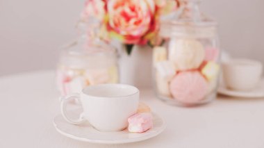 White cup with marshmallows. Romantic breakfast. Concept of holiday, birthday, Easter, International Womens Day. Feminine flat lay