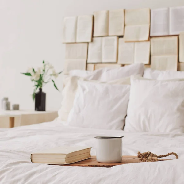 Spring still life. Breakfast in bed. White bedroom. Sweet home. Books and coffee cup. flat lay