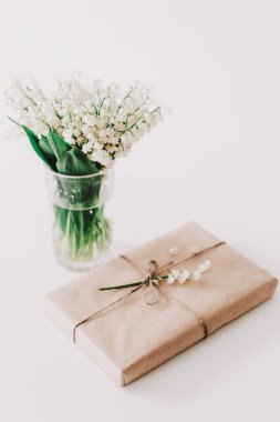 Beyaz arka planda kahve, hediye ve çiçeklerin romantik kompozisyonu. Tatil kavramı, doğum günü, Uluslararası Kadınlar Günü