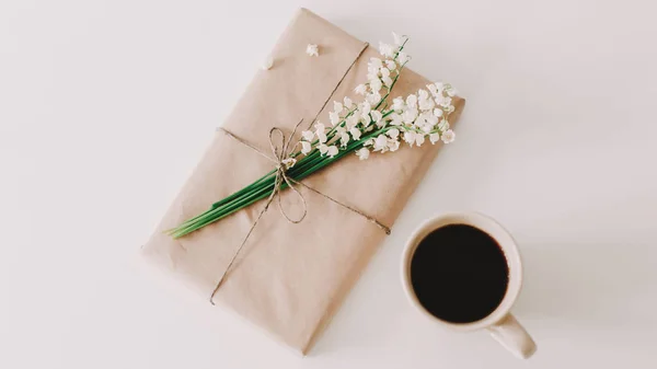 Romantic composition of cup of coffee, gift and flowers on white background. Concept of holiday, birthday, International WomensDay — Stock Photo, Image