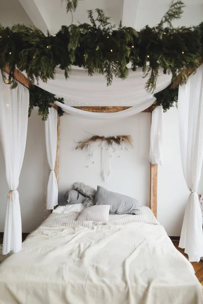Modern home interior design. Bed with wooden canopy and pillows, blanket. Bedroom interior, scandinavian style. Home decor. — Stock Photo, Image