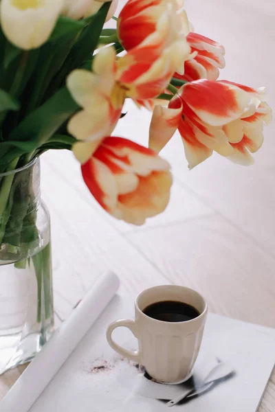 Coffee cup with tulips. Concept of holiday, birthday, Easter, March 8. flat lay