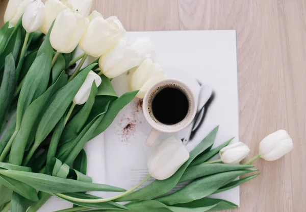 Coffee cup with tulips. Concept of holiday, birthday, Easter, March 8. flat lay