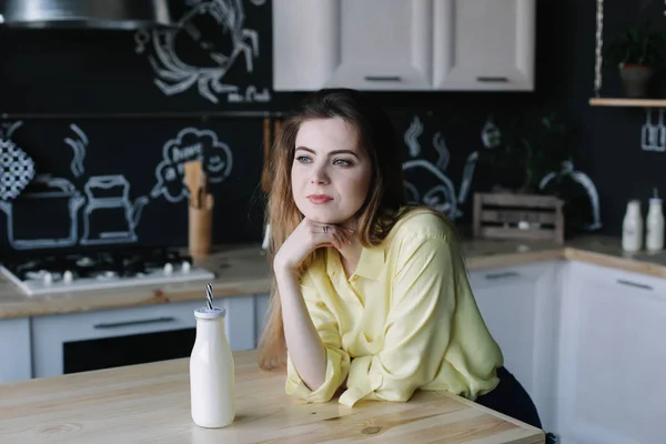 Een meisje dat thuis koffie drinkt in de keuken. Jonge vrouw met een kop koffie. Meisje drinkt drank in café. Goedemorgen.. — Stockfoto