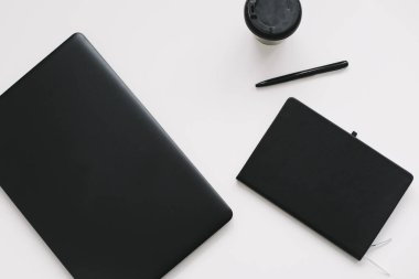 Workspace background with laptop, coffee, pen and notebook. Working, business, freelance concept. Copyspace, top view, flatlay