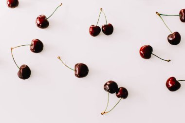 Beyaz arka planda izole edilmiş kirazlar. Düz yatış, üst görünüm.