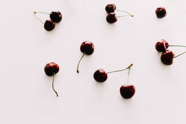 Beyaz arka planda izole edilmiş kirazlar. Düz yatış, üst görünüm.
