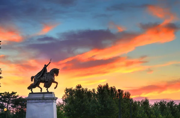 The sunset over the Apotheosis of St. Louis statue of King Louis IX of France, namesake of St. Louis, Missouri in Forest Park, St. Louis, Missouri.