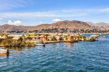 Floating islands made from reeds on Lake Titicaca under blue ski clipart