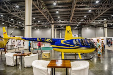 MOSCOW - AUG 2016: Robinson R44 helicopter presented at MIAS Moscow International Automobile Salon on August 20, 2016 in Moscow, Russia clipart