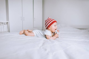 bebek çocuk oyuncak geyik yatakta oynamaktan pon pon ile kırmızı ve beyaz çizgili şapkalı