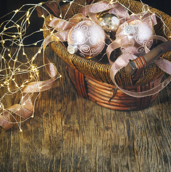 Christmas tree decoration glass balls in basket and light garlan — Stock Photo, Image