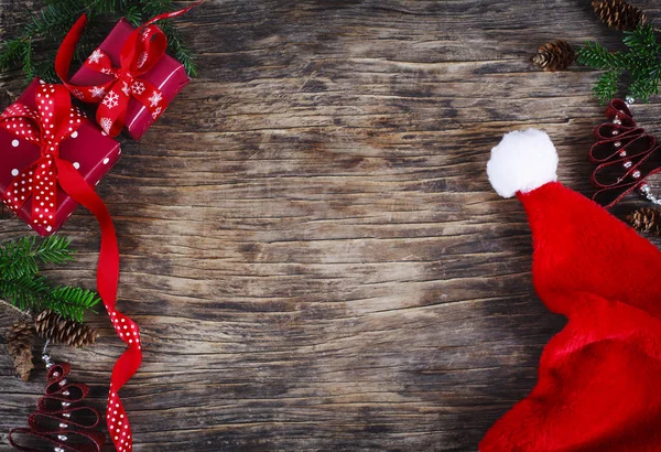 Vánoční pozadí. Santa klobouk, dárkové krabice a sváteční dekorace — Stock fotografie