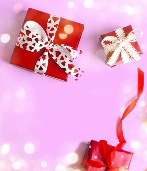 Holiday gifts. Red gift boxes on pinkbackground. Valentines day