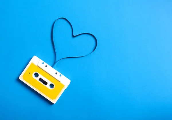 Cassette rétro avec bande en forme de coeur sur fond bleu — Photo