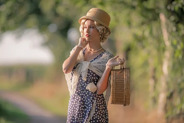 Frau steht mit Handtasche auf Feldweg — Stockfoto