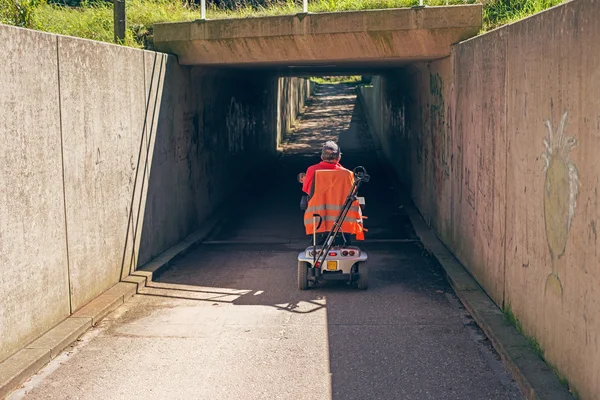 Man driving scooter into tunnel