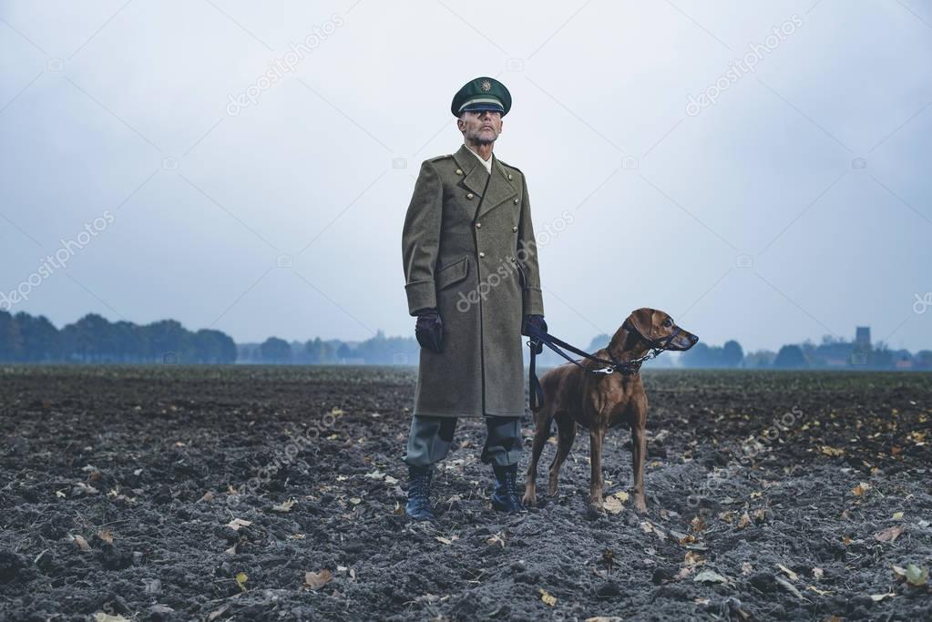 Patrolling military officer with dog