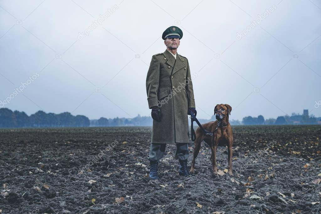 Patrolling military officer with dog