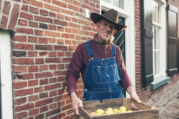 Farmer delivering a crate of fresh apples — Stock Photo, Image