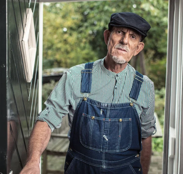 Vintage senior farmer wearing dungaree — Stock Photo, Image