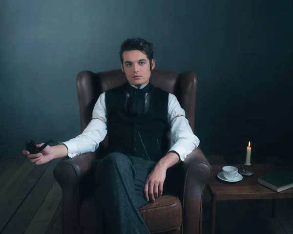 victorian man sitting in leather chair