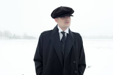 Kış kar manzarada duran gangster. 