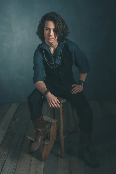 Fashion man sitting on wooden stool — Stock Photo, Image