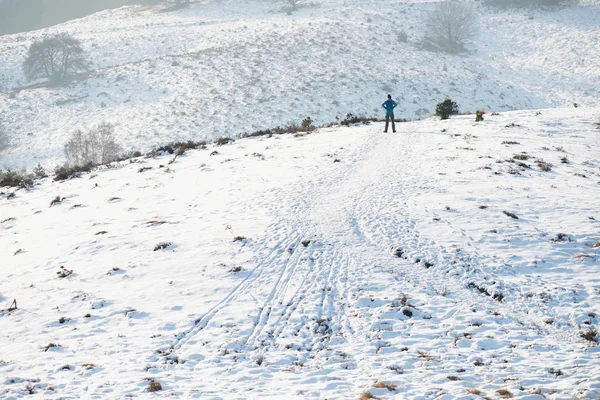 Hills in snow with hiker. — Stock Photo, Image