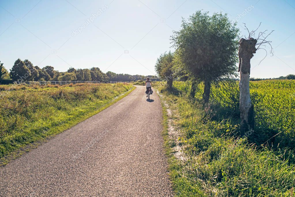 Rural road with tourist on bicycle 