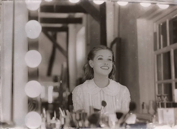 Young woman looking in mirror — Stock Photo, Image