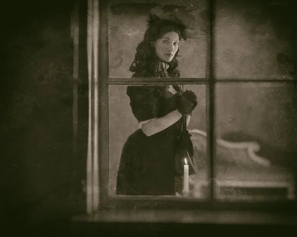 Viktorianische Frau steht hinter Fenster — Stockfoto