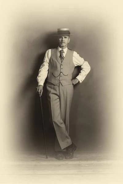 Dandy in suit standing with cane — Stock Photo, Image