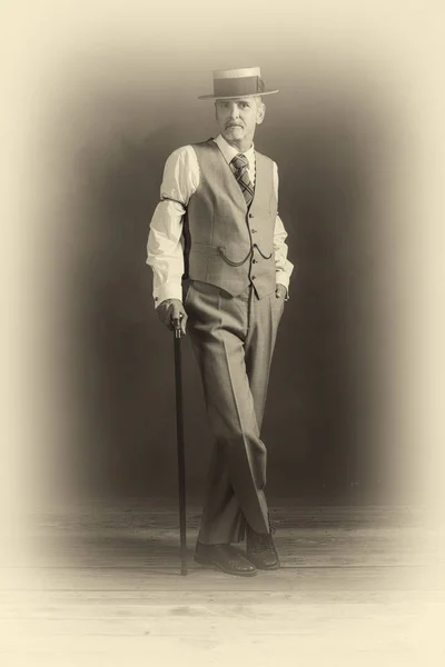 Dandy in suit standing with cane — Stock Photo, Image