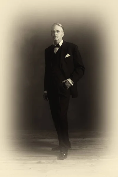 Businessman in black suit with bow tie — Stock Photo, Image