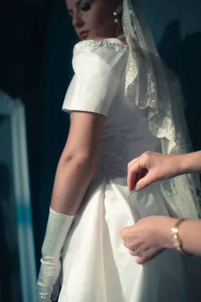 Bride looking at seamstress — Stock Photo, Image