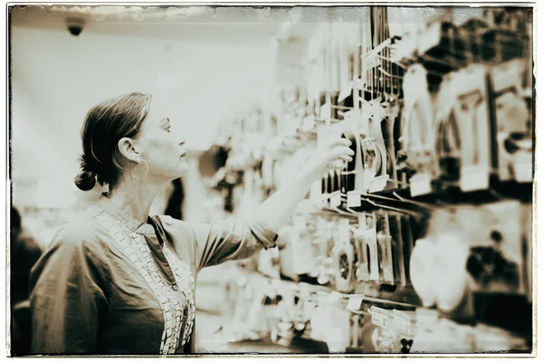 Woman looking on kitchen tools — Stock Photo, Image