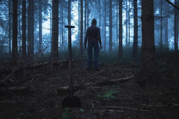 Shovel and man in misty forest — Stock Photo, Image