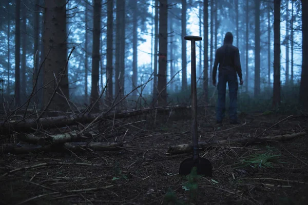 Shovel and man in misty forest — Stock Photo, Image