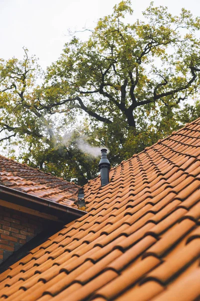 Roof with steaming stovepipe — Stock Photo, Image