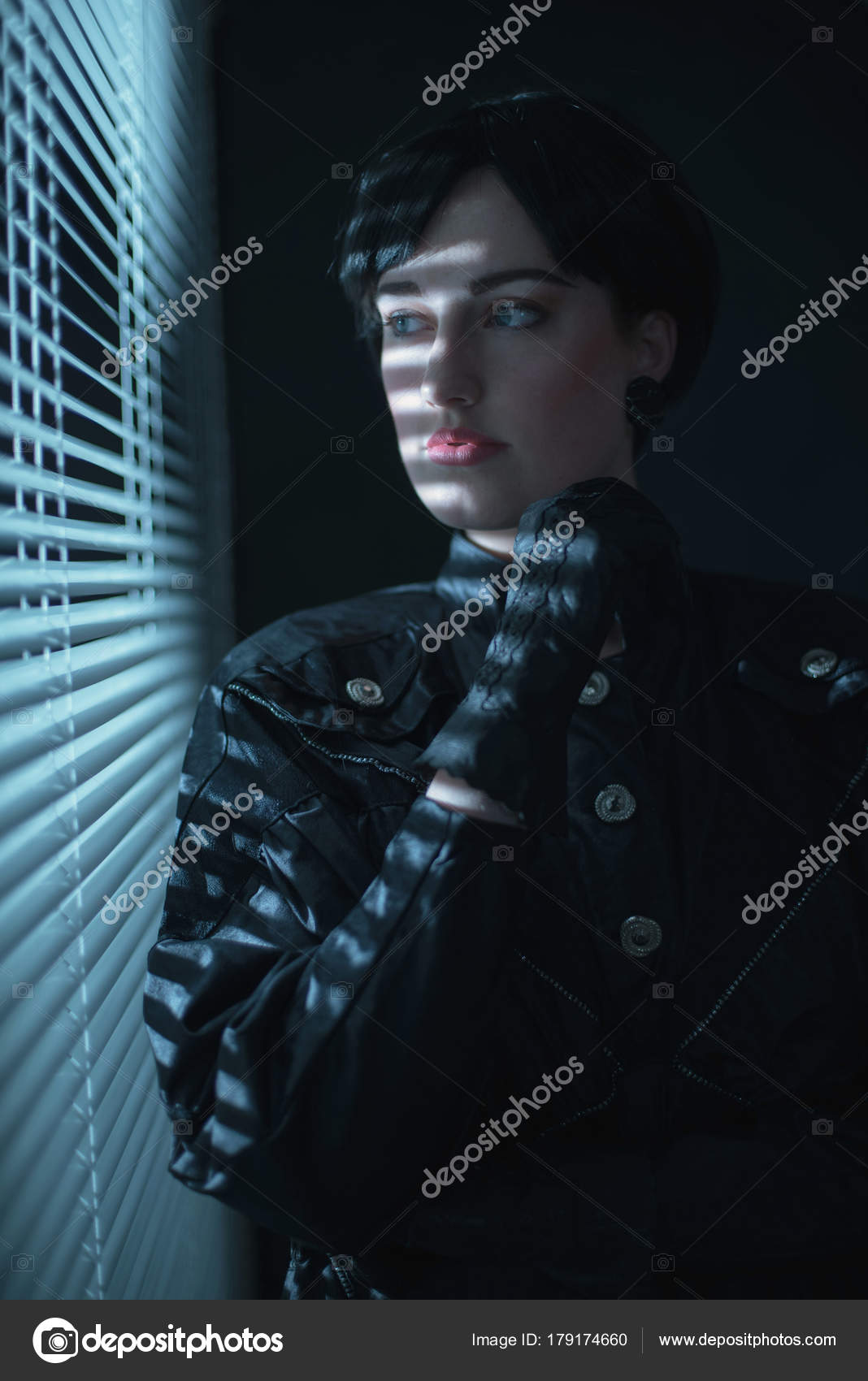 Woman looking through blinds — Stock Photo © ysbrand 179174660