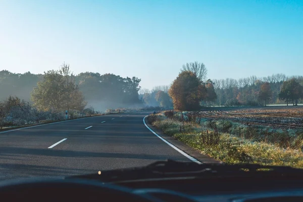 Road in misty rural landscape — Stock Photo, Image