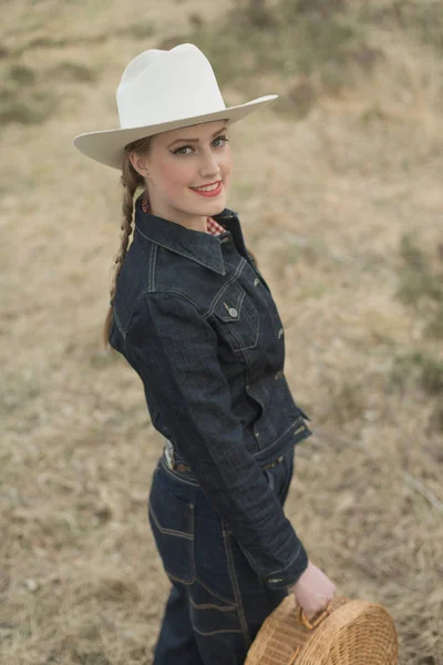 Smiling cowgirl in jeans Stock Image