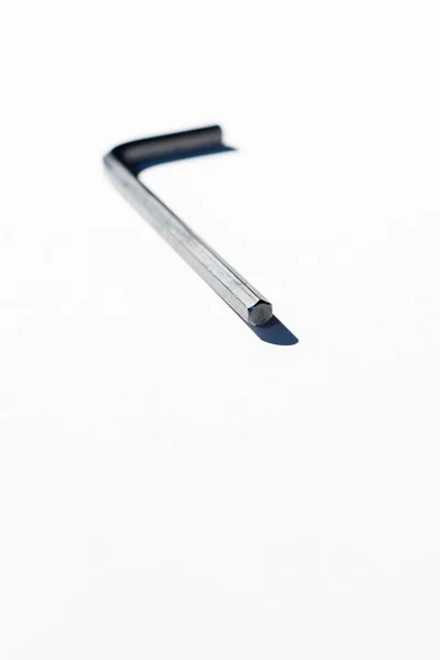 Hex key on white surface. — Stock Photo, Image