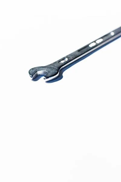 Open end chrome wrench on white surface. — Stock Photo, Image