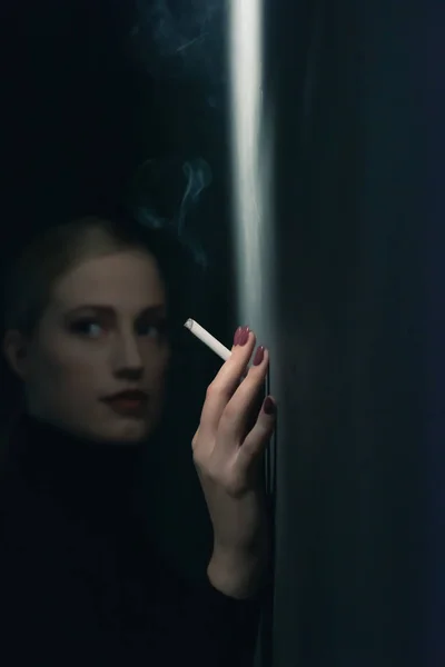 20世纪40年代的复古女性，身穿黑色高领毛衣麻风病，头戴香烟 — 图库照片