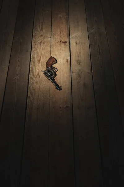 Historic revolver pistol on old wooden floor. — Stock Photo, Image