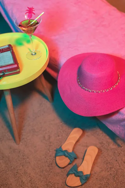 Pink beach hat on sunbed with vintage 1950an ladies shoes and yel — Stok Foto